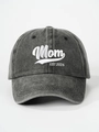 Close-up detail of Mom EST 2026 white embroidery on a washed grey cotton baseball cap - Black MOM