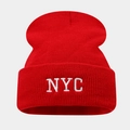 Detailed view of red NYC embroidered logo on rib-knit winter beanie hat with cuffed design - Red