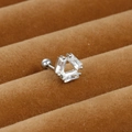 Macro view of silver steel cartilage stud featuring a triangle of clear zircon stones - Triangle Style