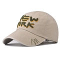 Close-up of 3D New York embroidery on washed cotton baseball cap with green trim details - Beige