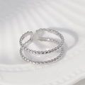 Minimalist silver double-layered open ring with beaded texture on a white surface - Steel Color-Beaded