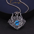 Detailed close-up of retro skull and blue devil eye pendant on a silver box chain - Standard Type / Blue
