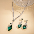 Dettaglio di parure vintage in argento con cristalli a cuore verde e strass scintillanti - Set Collana Verde (2 Pezzi)