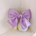 Elegant purple satin oversized bow hair clip placed against a minimalist white background - Spring Clips / Purple