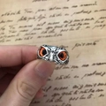 Macro detail of retro owl ring featuring vintage silver finish and vibrant orange eyes - Orange