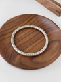 Silver titanium steel bracelet with spiral texture on a wooden tray - Silver Spiral
