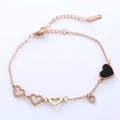 Elegante pulsera de corazón en oro rosa con esmalte negro y dijes de corazones - Oro rosa