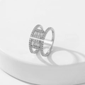 Macro detail of silver double-row ring with pave set cubic zirconia on white base - Style 4 / Silver