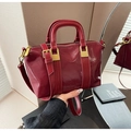 Détail du sac à main en cuir verni bordeaux avec boucles dorées et bandoulière réglable - Bordeaux