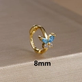 Detailed macro view of 8mm golden butterfly hoop earring with blue and clear zircon - 8mm / Gold-Blue