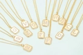 Gold initial pendant necklace set with sparkling cubic zirconia on a light background - Letter A / Gold