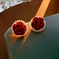 Detailed view of red velvet flower earrings with pearl border on a luxury jewelry box - Silver Earring Post - Red (Real Gold Plated)
