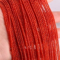Strand of 2mm to 3mm round red agate beads with a translucent polished finish - Red Agate