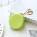 Light green round silicone coin purse with gold keychain for earphone storage - Green