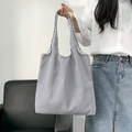Detailed shot of large blue and white striped canvas tote bag held by a model - Blue White Vertical Stripe