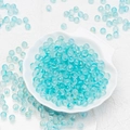 Macro shot of 6mm blue frosted glass beads with gold sparkles in a white shell bowl - 8mm Light Blue with Gold Glitter