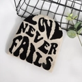 Classic beige knitted beanie with black Love Never Fails jacquard lettering - One Size / Beige