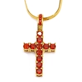 Macro detail of a gold cross pendant with red zircon inlay on a snake chain necklace - Gold Red