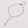 Macro detail of silver stainless steel rosary bracelet with heart and cross pendant - Style 1 / Steel