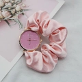 Detailed shot of pink ribbon scrunchie strap watch with rose gold dial and floral card - Pink