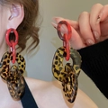 Macro shot of oversized acrylic resin hoop earrings featuring a trendy leopard print pattern - 42# 925 Sterling Silver Earring Post - Brown Red - Leopard Print