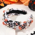 Halloween knotted headband with orange pearls and rhinestones on festive pumpkins background - Knotted Skull White Style With Pearls
