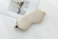 Champagne silk sleep mask with elastic strap and satin finish on white background - Light Camel