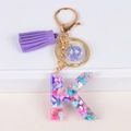 Colorful resin letter K keychain with purple tassel and gold ring on white surface - Letter K(5859543255619)