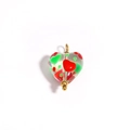 Detailed close-up of heart-shaped glass bead with red and green patterns and gold accents - Transparent Red & Green Pattern (Style 7)