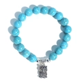 Turquoise bead bracelet with a silver owl pendant and metallic spacers on white background - Blue Turquoise Owl Charm