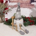 Gnome doll on wood chair with pine branches and red berries for Christmas decor - Long Leg Doll / Gray