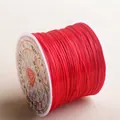 Close-up of red elastic crystal string roll for DIY jewelry making and beading - Red