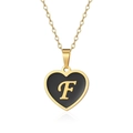 Detail of gold heart pendant necklace featuring black enamel inlay and gold letter F engraving - Letter F Style
