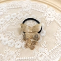 Elegant gold metal butterfly hair tie with embossed texture on black elastic band - Gold Double Butterfly