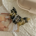 Detail of bat-shaped hair claw clip with black and yellow marble pattern finish - Black and Yellow Pattern