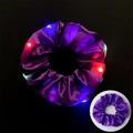 Purple satin LED light-up scrunchie glowing with colorful fiber optics in dark - Glowing Purple