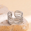 Layered silver titanium steel ring with wavy and beaded bands on a natural stone base - Steel Color 106