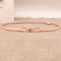 Detail of light pink slim belt with interlocking gold buckle on a linen background - Pink