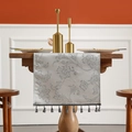 Silver-grey woven table runner with floral embroidery and decorative tassel accents - Silver Gray