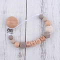 Detail of baby pacifier clip with beech wood, silicone beads and BABY letter engraving - Taupe