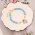 Detail of blue clay bead bracelet with heart pendant and pearls in a ceramic dish - 7# Spotted Blue