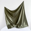 Close-up of dark green satin silk scarf draped on a table with soft shadows - 90*90cm / Army Green