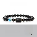 Macro shot of Sagittarius zodiac bracelet with matte black beads and engraved logo - No Card / Sagittarius