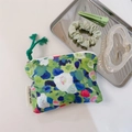 Detailed macro view of oil painting style canvas coin purse with green floral print - Green Base Blue Pink White Small Floral
