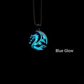 Vintage dragon totem necklace with glowing blue fluorescence in dark lighting - Blue Light