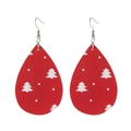Detail view of red teardrop faux leather earrings with white Christmas tree patterns - Red Base White Tree Dots