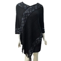 Detail shot of black knitted poncho with blue diamond pattern and elegant tassel fringe - Twill Black