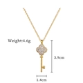 Detail view of lucky clover key pendant with rhinestones and measurement annotations - Gold