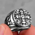 Macro shot of vintage Saint Benedict medal ring in steel with black enamel cross details - Steel