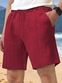 Close-up of red men's casual shorts showing jacquard fabric texture and drawstring waist - Burgundy